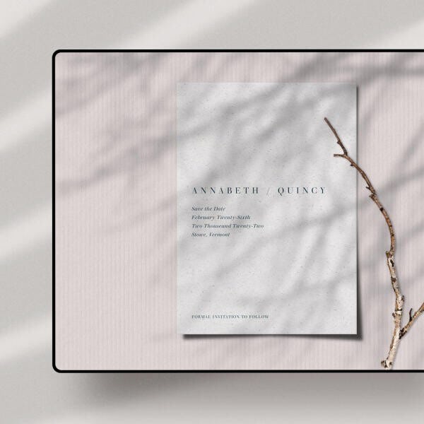 An iPad screen showing a white online save the date for a couple named Annabeth and Quincy